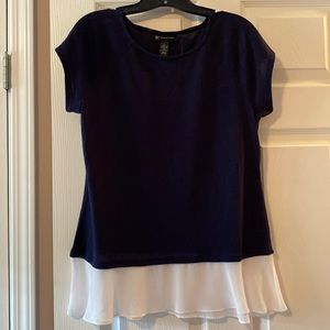 Navy blue sweater with ruffle trim.